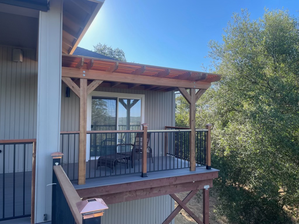 Elevated covered deck with timber-frame awning and outdoor seating