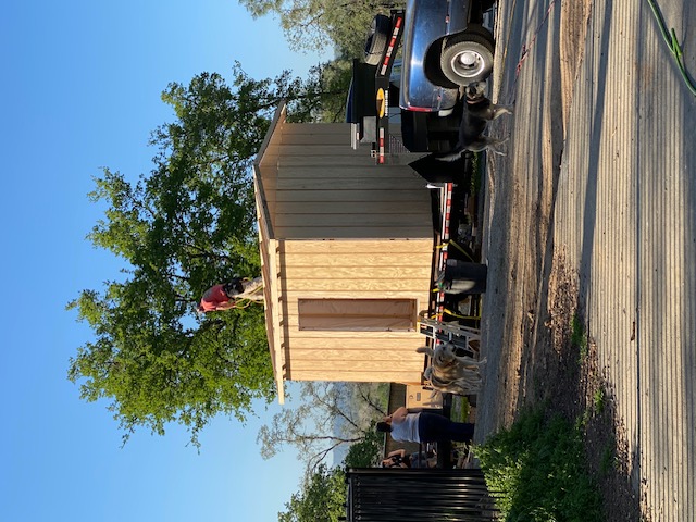 Installing the roof on a custom shed — crew on site