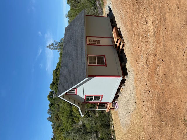 Completed tiny home rear view on hillside property