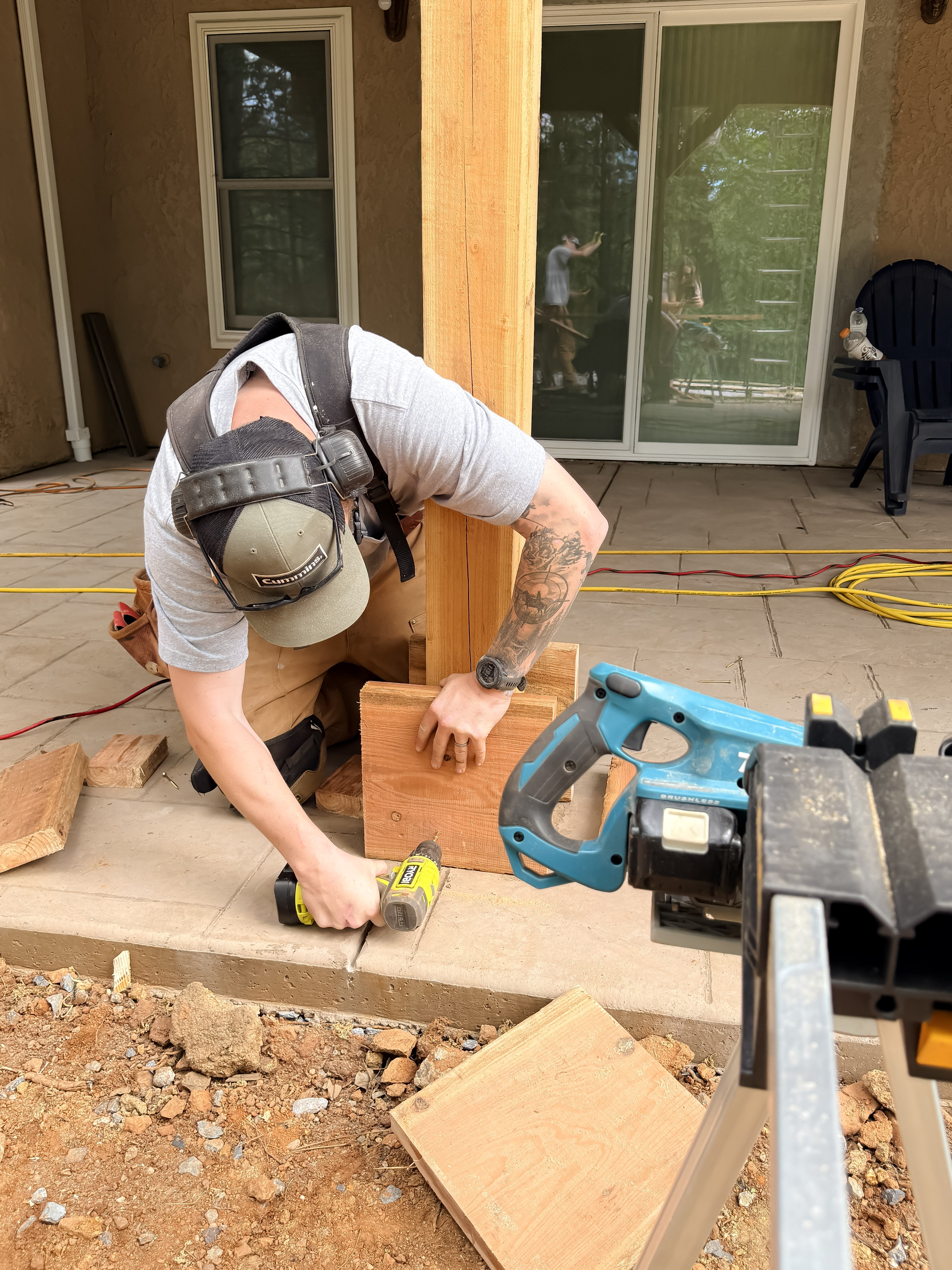 Jake cutting timber post with reciprocating saw