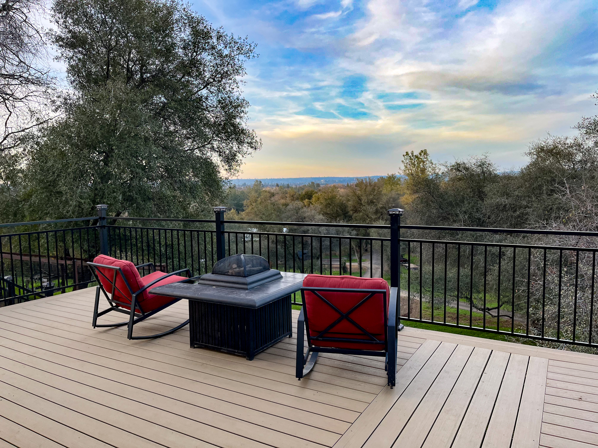 Composite deck with fire pit and hillside view
