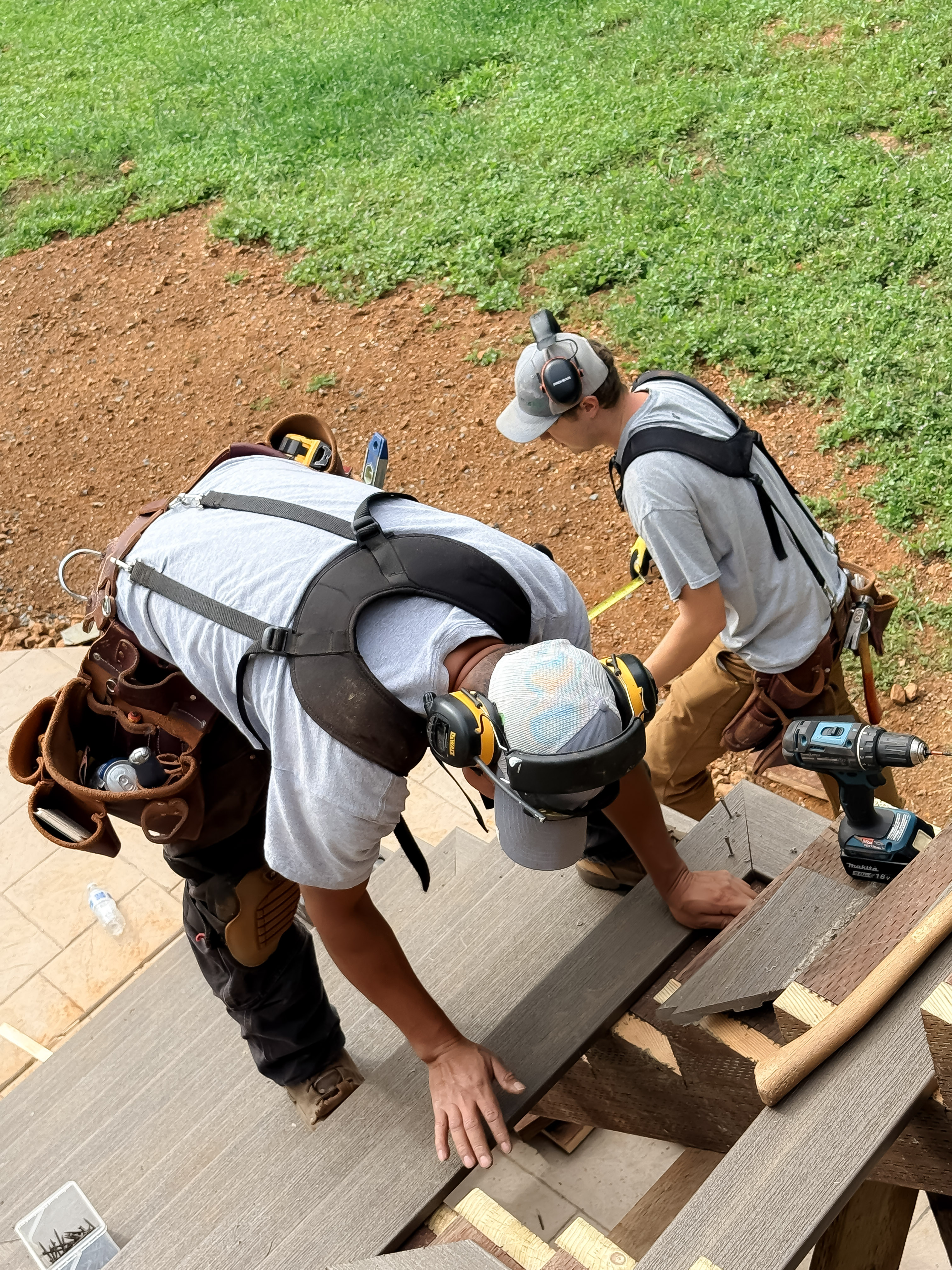 Two workers laying decking boards