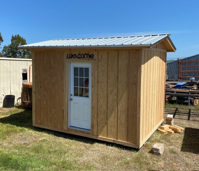 Finished custom shed with Welcome sign